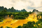 Detian transnational waterfall turns golden